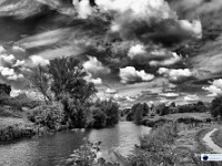 An Accumulation Of Cumulus  Photographing the Medway, I am frequently blessed with really impressive skies. This photograph was taken from a similar spot to “The Sublime View” on a breezy day when there was a strange mix of high altitude cirrus clouds and lower level cumulus. The sky was a rich blue, but was not reflected well in the wind-rippled river. That is one reason this photo was rendered in monochrome.		£200